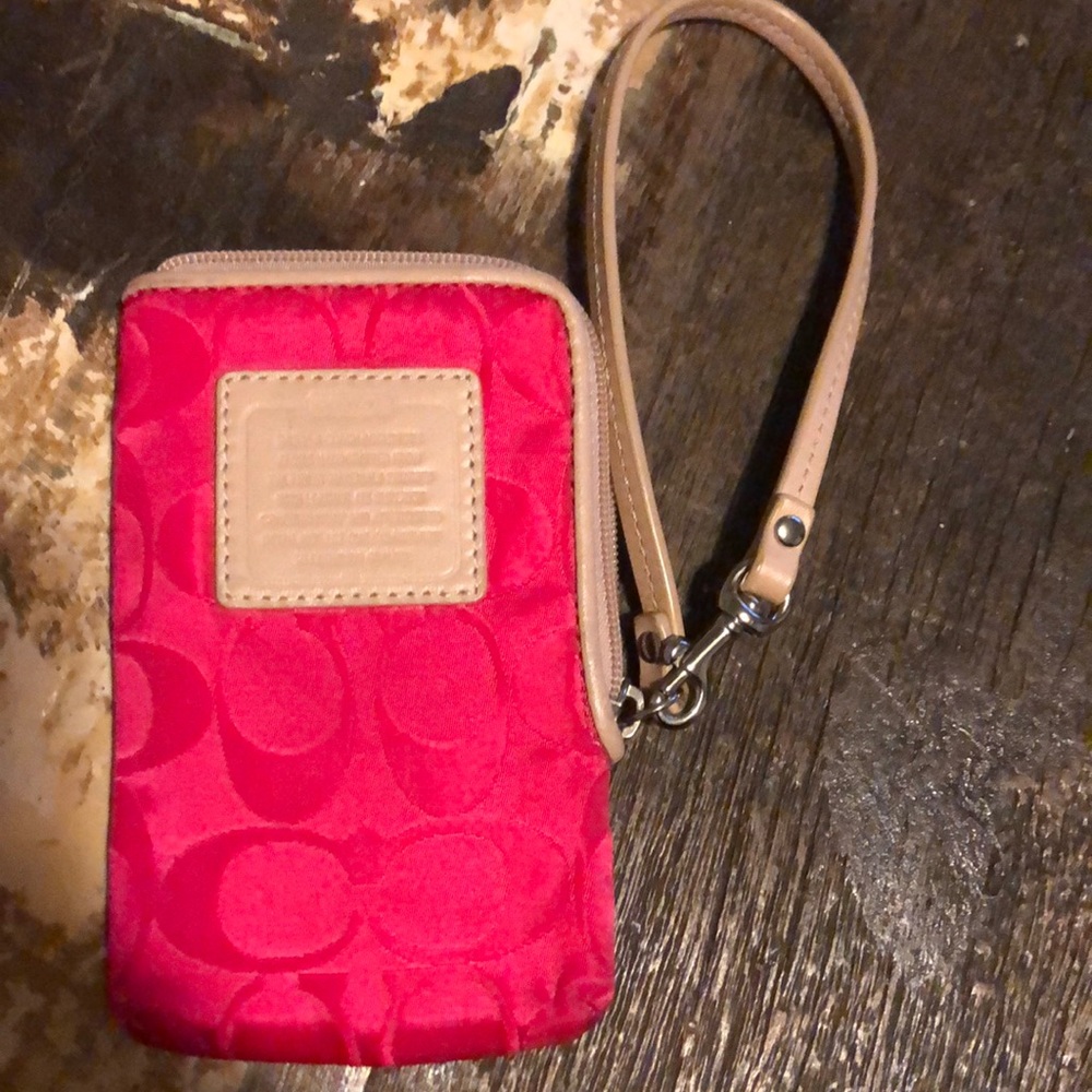 Coach, pink wristlet. Yellow interior.
